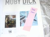 a book with a pink sticker on it sitting on a bed