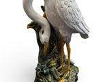 a white bird that is standing on a tree stump