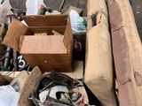 a pile of junk sitting on the ground next to a forklift