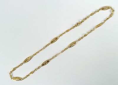 a close up of a gold chain on a white background