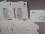 many envelopes of different sizes and colors on the table