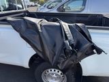 a black tarp on the back of a white truck