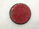 a small red object on a white surface