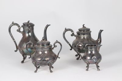 two silver teapots with handles and handles on a white background