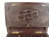 a wooden box with a bunch of keys inside of it