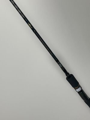 a close up of a fishing rod on a white surface