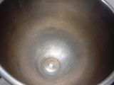 a large metal bowl sitting on top of a stove