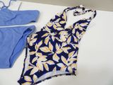 two swimsuits on a table next to a pair of scissors