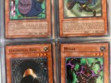 four different pokemon cards in a plastic case on a table