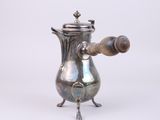 an antique silver coffee pot with a wooden handle on a white background