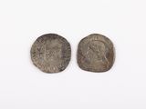 two silver coins, one of which is a woman and the other of which is a man