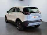 the rear end of a white car in a showroom