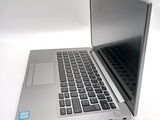 a silver laptop computer sitting on top of a white table