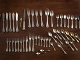 a lot of spoons and forks on the table