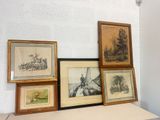 many framed pictures on a shelf in a room