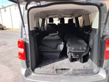 the back of a van with luggage in the trunk of it
