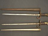 three old swords are sitting next to each other on a table