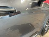 a close up of a car door handle with a sticker on it