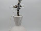 a white vase with a silver horn on top of it