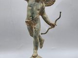 an image of a statue of a cupid holding a bow and arrow
