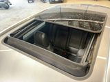 a silver car with a window open in a garage