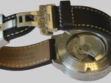 a close up of a wrist watch on a white surface