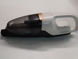 a small black and white vacuum on a white table