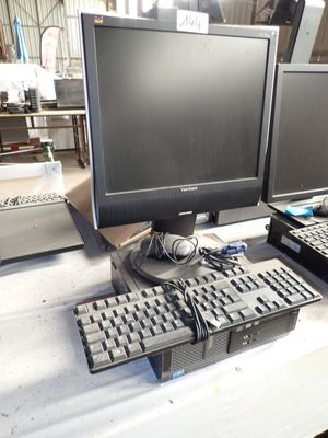two computer monitors and a keyboard on a table