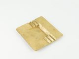 a close up of a gold plate with a key on it