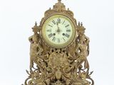 a gold clock that is sitting on top of a table