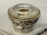 a silver container with a glass lid next to a pair of scissors