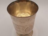 a silver cup that is sitting on a table
