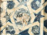 an old photo of a blue and white tile with a star design