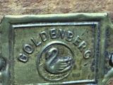 a close up of a brass plate with a swan on it