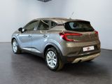 the rear end of a silver car in a showroom