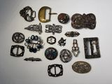 many different types of belts and buckles on the table