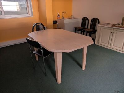 a table and chairs in a room with yellow walls