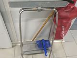 un balai et un porte-balai dans un coin de la pièce