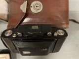 a camera and a case sitting on a table next to each other