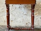 a small wooden table with a drawer on top of it