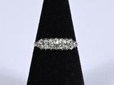 a close up of a diamond ring on a black ring stand