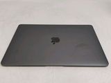 an apple macbook pro laptop computer sitting on top of a white surface