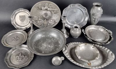 a lot of silver plates and bowls on the table