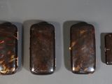 three lighters are lined up on a table with a lighter in the middle of them