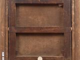 a close up of a wooden frame with a button on it