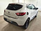 the rear end of a white car parked in a garage