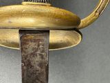 a close up of a sword with a metal handle