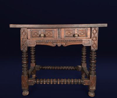 an old wooden table with two drawers on top of it