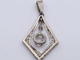 an image of a diamond shaped pendant with a ring in the center