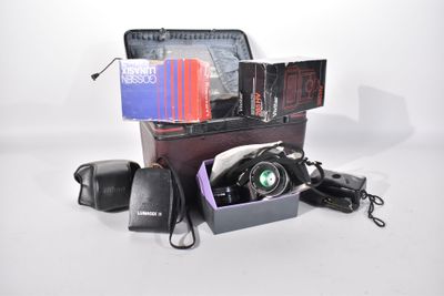 a suitcase with a camera and other items in it